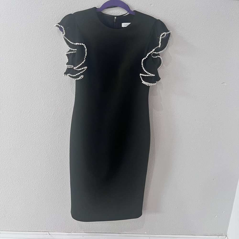 Black cocktail dress with pearls on the sleeves